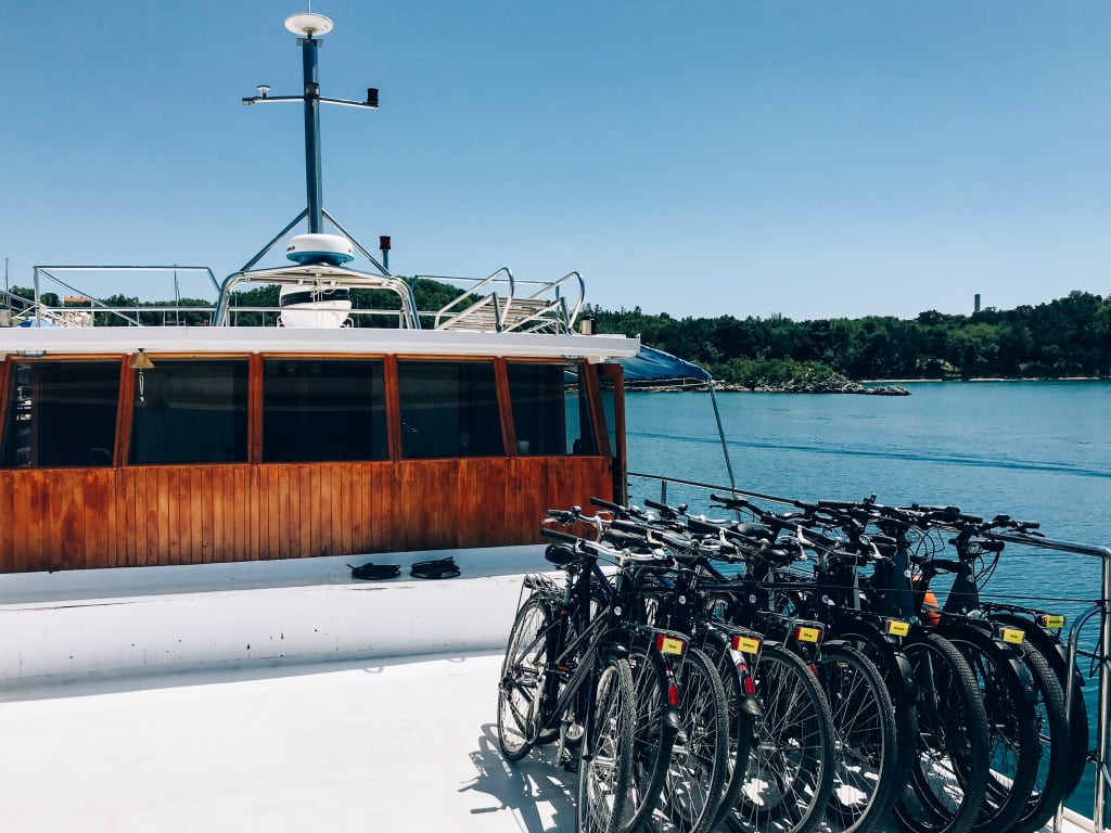 Bicycles lined up on the wooden deck of a boat sailing along the waters of the Kvarner Gulf, Dalmatia
